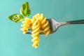 twisted pasta on a fork with a leaf. Royalty Free Stock Photo