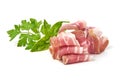 Twisted pieces of pork farmer meat or bacon with parsley, isolated on white background