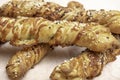 Twisted puff pastry sticks on white paper parchment Royalty Free Stock Photo