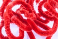 Twisted red pipe cleaners Royalty Free Stock Photo