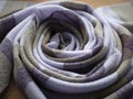 Twisted into a ring violet and olive scarf. Hand woven cashmere shawl. Concept of fashion, weaving and artisanship