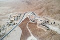 Twisted road and aerial view of well-planned residential area built in the Judean desert, Israel. The oasis with modern