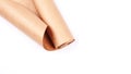 Twisted into roll brown wrapping paper on white background. Royalty Free Stock Photo
