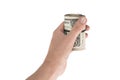 Twisted roll of dollars tightened rubber band in the hand Royalty Free Stock Photo