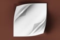 A twisted square stack of white paper on a brown background