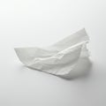 A twisted, thin sheet of white paper rests on a smooth, white surface. The paper is Royalty Free Stock Photo