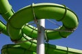 Twisting green water slide in an outdoor water park Royalty Free Stock Photo