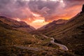 Twisty road down a mountain valley towards the sea with colorful sunset. Gran Canaria, Canary Islands Royalty Free Stock Photo