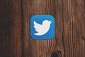 Blue twitter logo on wood background