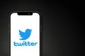 Twitter logo on smartphone screen on black background
