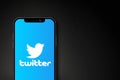 Twitter logo on smartphone screen on black background