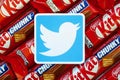 Twitter paper logo on many Kit Kat chocolate covered wafer bars in red wrapping. Advertising chocolate product in Twitter social