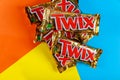 Twix chocolate bars on orange blue and yellow background