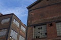 Two abandoned industrial buildings against a blue sky Royalty Free Stock Photo
