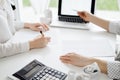 Two accountants using a laptop computer for counting taxes at white desk in office. Business Woman pointing into screen Royalty Free Stock Photo