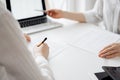 Two accountants using a laptop computer for counting taxes at white desk in office. Business Woman pointing into screen Royalty Free Stock Photo