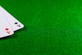 Two aces on the green felt casino table. Royalty Free Stock Photo