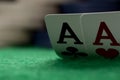 Two aces on green table with blurry chips Royalty Free Stock Photo