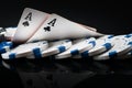 Two aces and poker chips, on a black background with mappings Royalty Free Stock Photo