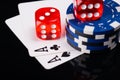 Two aces, poker chips and red cubes, on a black background with mappings Royalty Free Stock Photo
