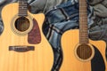 Two acoustic guitars on a cozy plaid, top view. Royalty Free Stock Photo