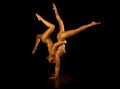 Two acrobatic girl toned in gold Royalty Free Stock Photo