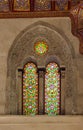 Two adjacent perforated stucco arched windows with colorful stain glass patterns, at Qalawun complex, Cairo, Egypt