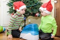 Two adorable boys playing with working humidifier, waiting for x-mas Royalty Free Stock Photo