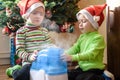 Two adorable boys playing with working humidifier, waiting for x-mas Royalty Free Stock Photo