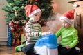 Two adorable boys playing with working humidifier, waiting for x-mas Royalty Free Stock Photo