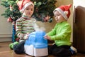 Two adorable boys playing with working humidifier, waiting for x-mas Royalty Free Stock Photo