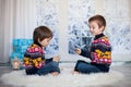 Two adorable children, boy brothers, playing cards at home, wintertime Royalty Free Stock Photo