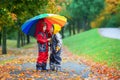 Two adorable children, boy brothers, playing in park with umbrel Royalty Free Stock Photo