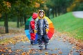 Two adorable children, boy brothers, playing in park with umbrella Royalty Free Stock Photo