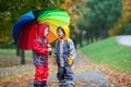 Two adorable children, boy brothers, playing in park with umbrella Royalty Free Stock Photo