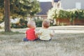 Caucasian babies sitting together in field meadow outside Royalty Free Stock Photo