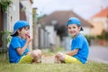 Two adorable little children, boy brothers, eating strawberries, summertime Royalty Free Stock Photo