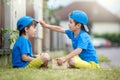 Two adorable little children, boy brothers, eating strawberries, summertime Royalty Free Stock Photo