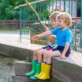 Two adorable little friends fishing with selfmade rod Royalty Free Stock Photo