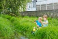 Two adorable little friends fishing with selfmade rod Royalty Free Stock Photo
