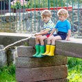 Two adorable little friends fishing with selfmade rod Royalty Free Stock Photo