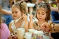 Two adorable little girls are eating at family picnic on summer day. Royalty Free Stock Photo