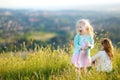 Two adorable little girls having fun in a meadow Royalty Free Stock Photo