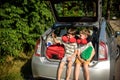 Two adorable little kids boy sitting in car trunk just before leaving for summer vacation. Sibling brothers making selfie on Royalty Free Stock Photo