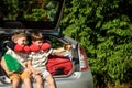 Two adorable little kids boy sitting in car trunk just before leaving for summer vacation. Sibling brothers making selfie on Royalty Free Stock Photo