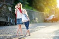 Two adorable little sisters having fun together on warm and sunny summer evening in Desenzano del Garda town, Italy Royalty Free Stock Photo