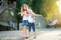 Two adorable little sisters having fun together on warm and sunny summer evening in Desenzano del Garda town, Italy Royalty Free Stock Photo