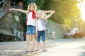 Two adorable little sisters having fun together on warm and sunny summer evening in Desenzano del Garda town, Italy Royalty Free Stock Photo