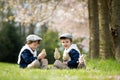 Two adorable preschool children, boy brothers, playing with little chicks Royalty Free Stock Photo