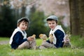 Two adorable preschool children, boy brothers, playing with little chicks Royalty Free Stock Photo